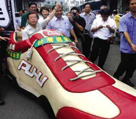 谢长廷坐“鞋子”车大赞台湾鞋品最棒